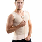 A man wearing a beige compression vest over black pants, standing against a solid white background.