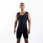 A man modeling a black athletic compression suit with integrated shorts and a front zipper, standing against a plain white studio background.