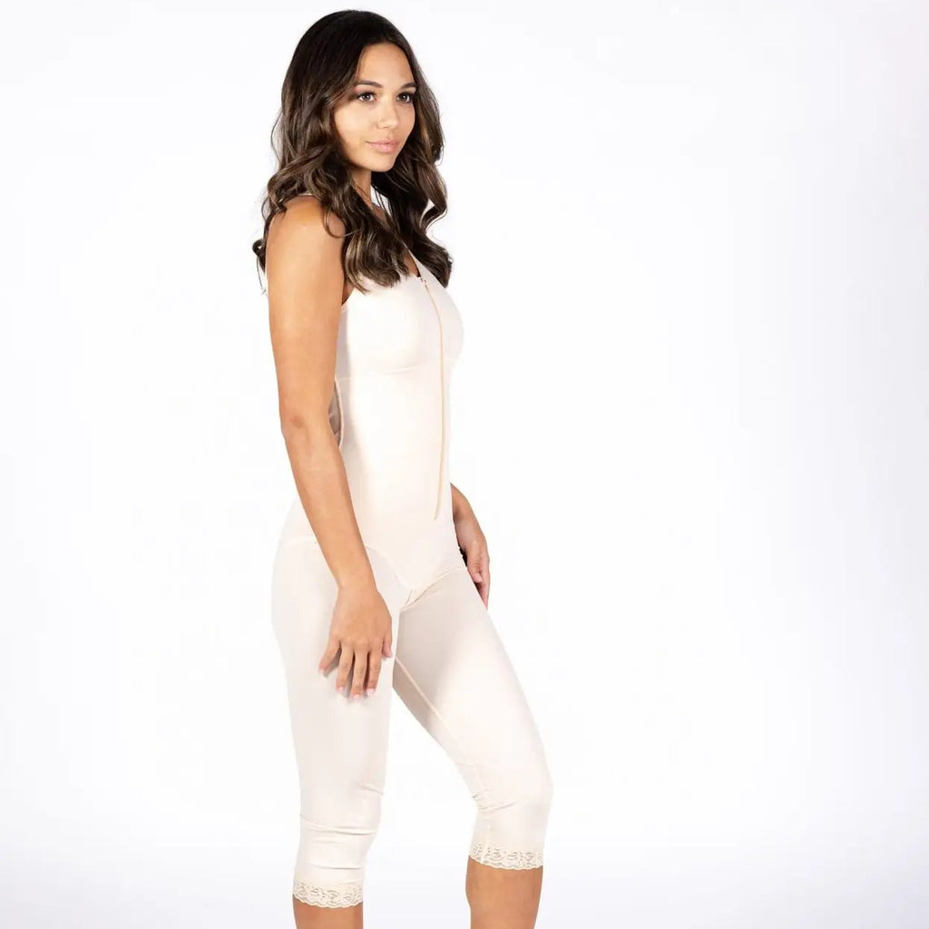 A woman modeling a light beige compression or shapewear bodysuit with capri-length legs, shown in profile against a plain white studio background.