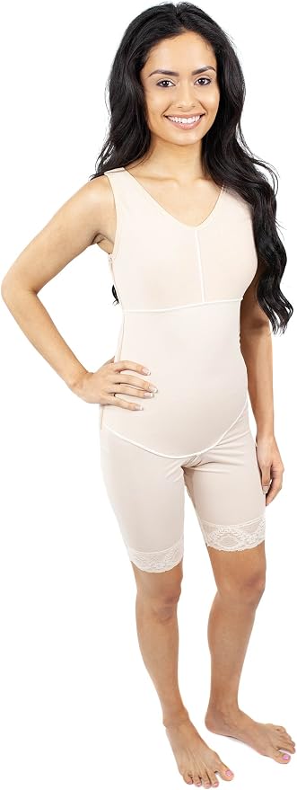 A woman modeling a light beige maternity shapewear bodysuit with built-in compression shorts, shown against a plain white background.