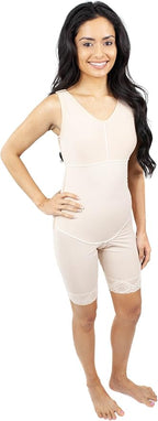 A woman modeling a light beige maternity shapewear bodysuit with built-in compression shorts, shown against a plain white background.