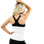 A blonde woman shown from the back wearing a white waist trainer corset over a black sports bra and black leggings, set against a plain white background.