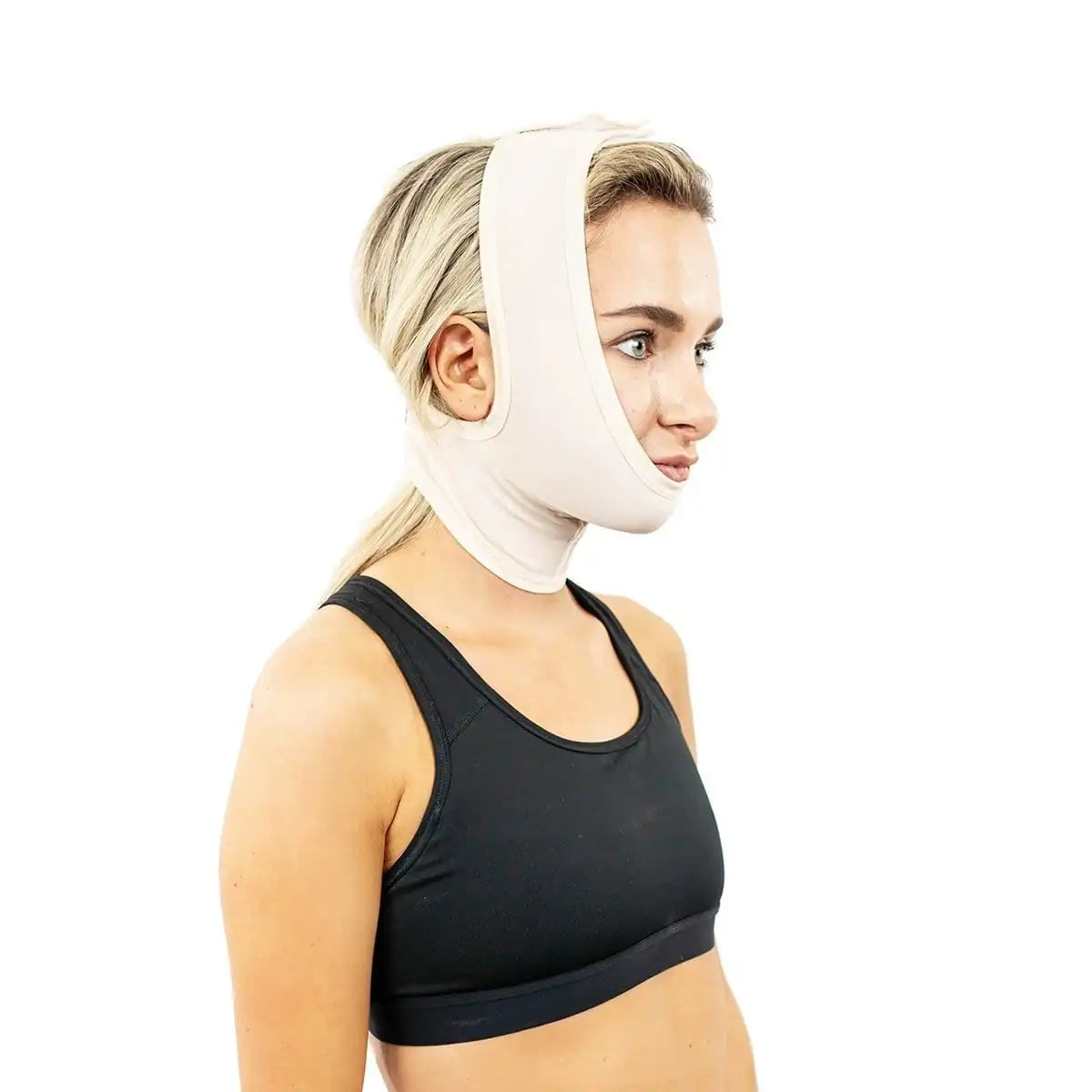A woman in a black sports bra wearing a beige chin and neck support brace, shown in profile against a solid white background.